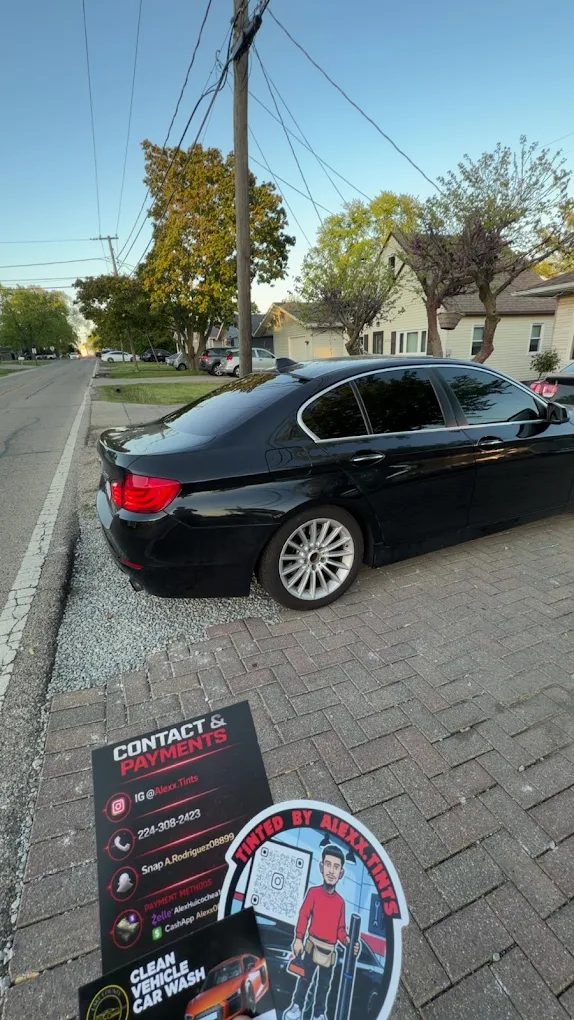 Black BMW sedan with full window tint — Round Lake, IL
