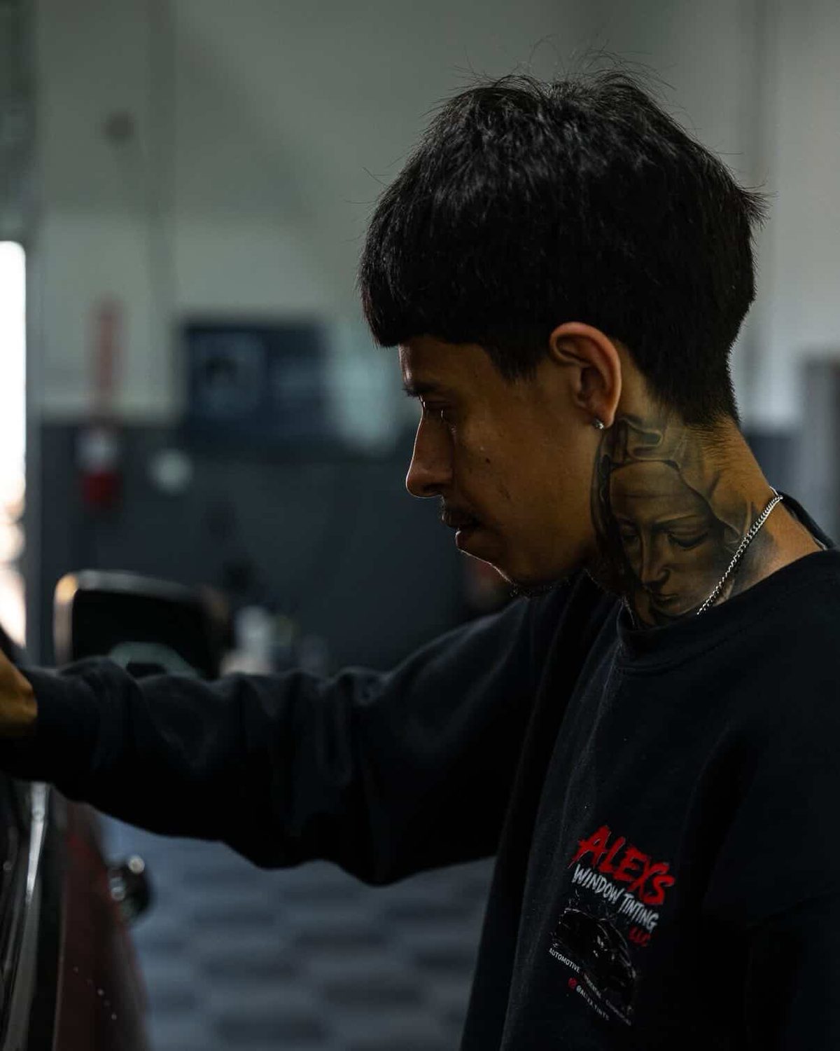 Alex hand-installing window tint on a vehicle