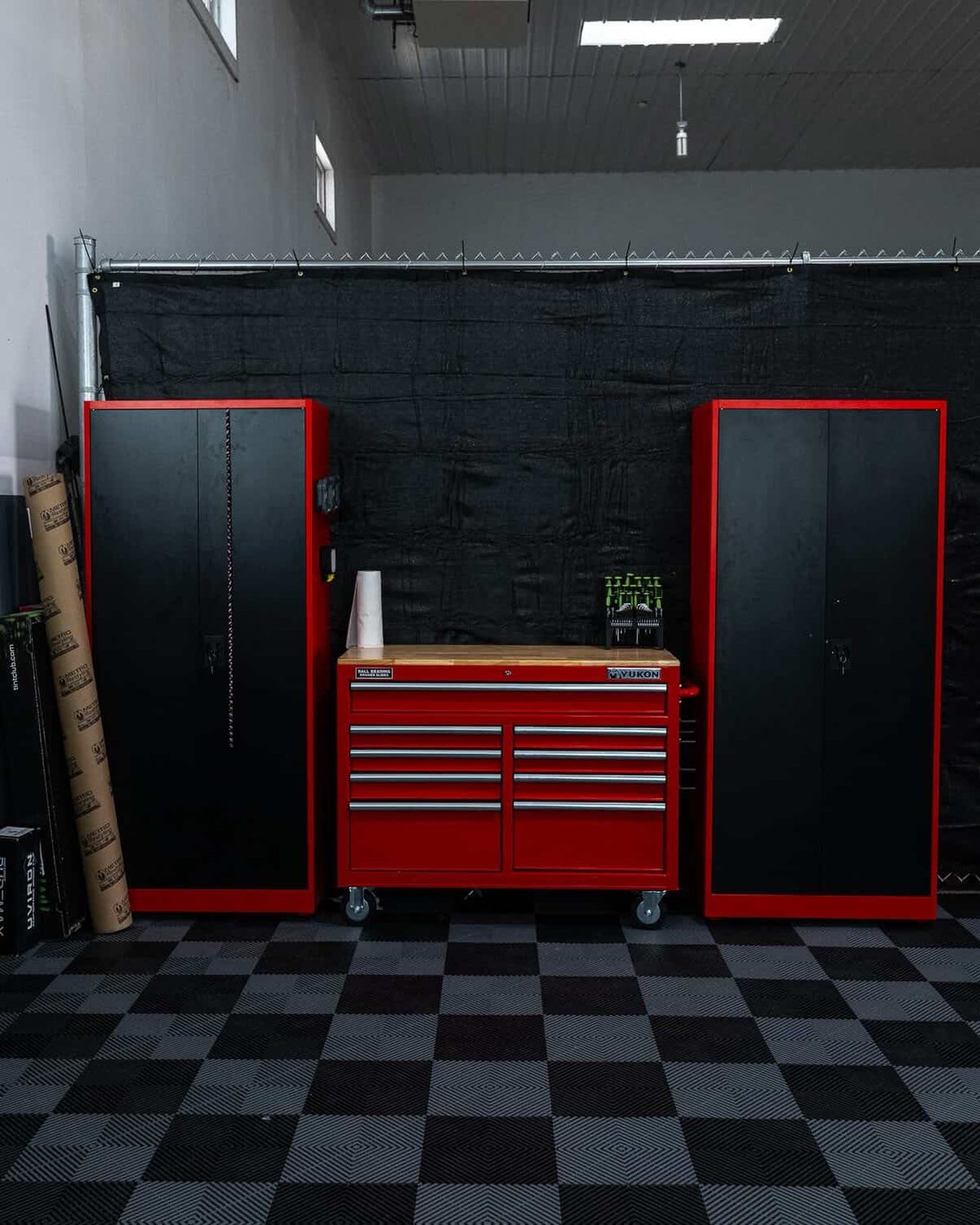 Organized tool cabinets and workbench inside the tint shop